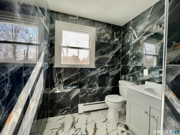 a bathroom with a toilet a sink and a shower