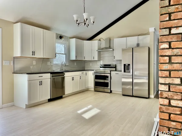 a kitchen with stainless steel appliances a refrigerator sink and cabinets