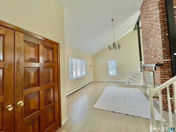 a spacious bedroom with a bed and a dresser next to a window