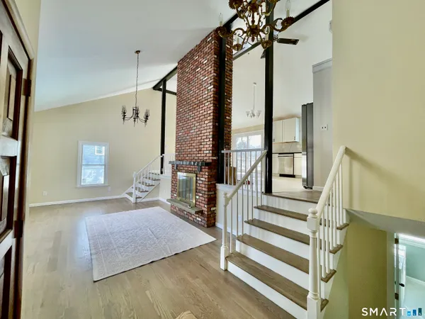 a view of entryway dining room and hall with wooden floor
