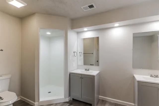 a bathroom with a sink a toilet and mirror