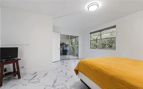 a bedroom with a bed and a television