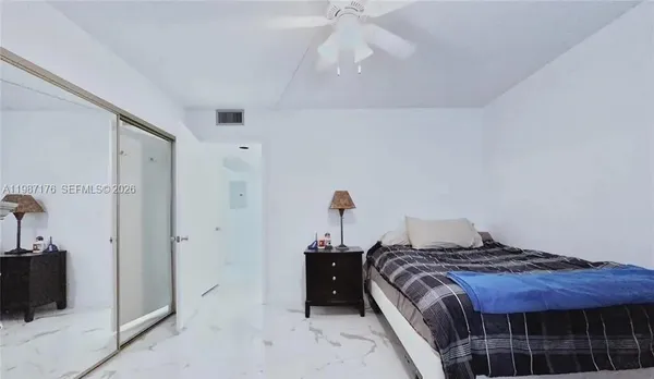 a bedroom with a bed and a mirror