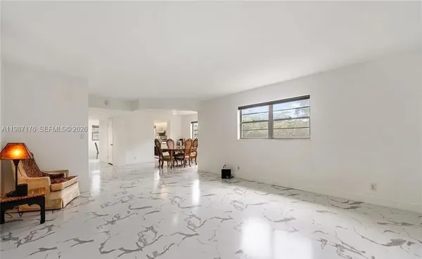 a view of empty room with furniture and a window