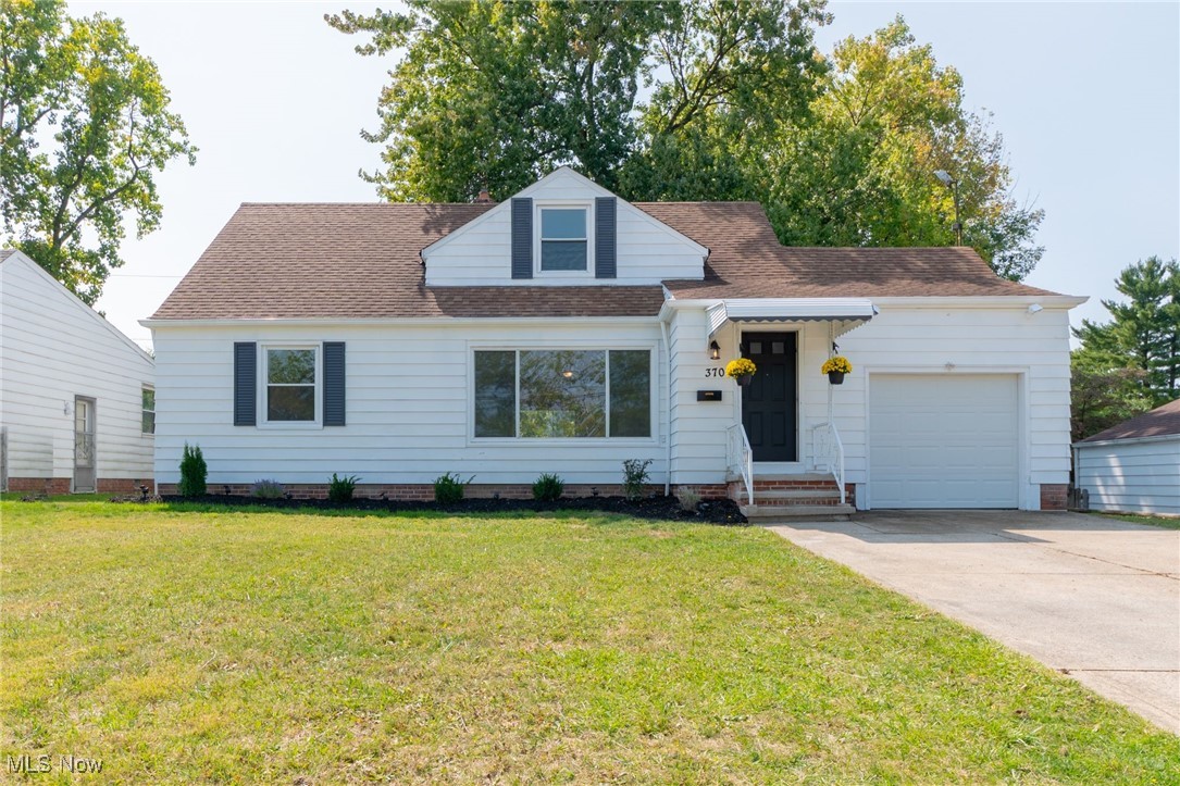 370 South Green Road Cleveland, OH 44121 - Photo 1 of 34 New england style home with a garage and a front lawn