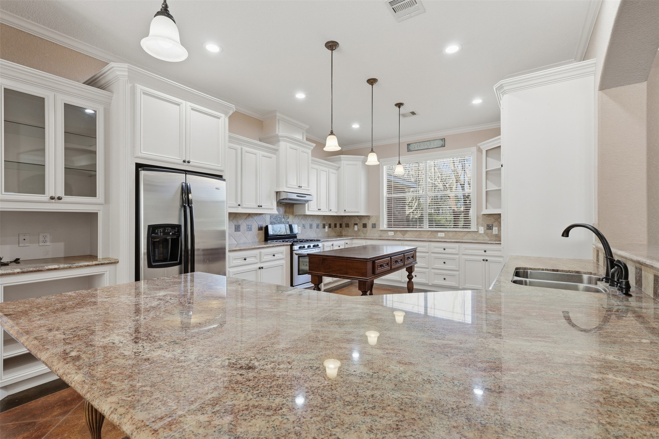 500 Burwell Road Highlands, TX 77562 - Photo 13 of 50 a kitchen with stainless steel appliances granite countertop a stove a sink and a refrigerator