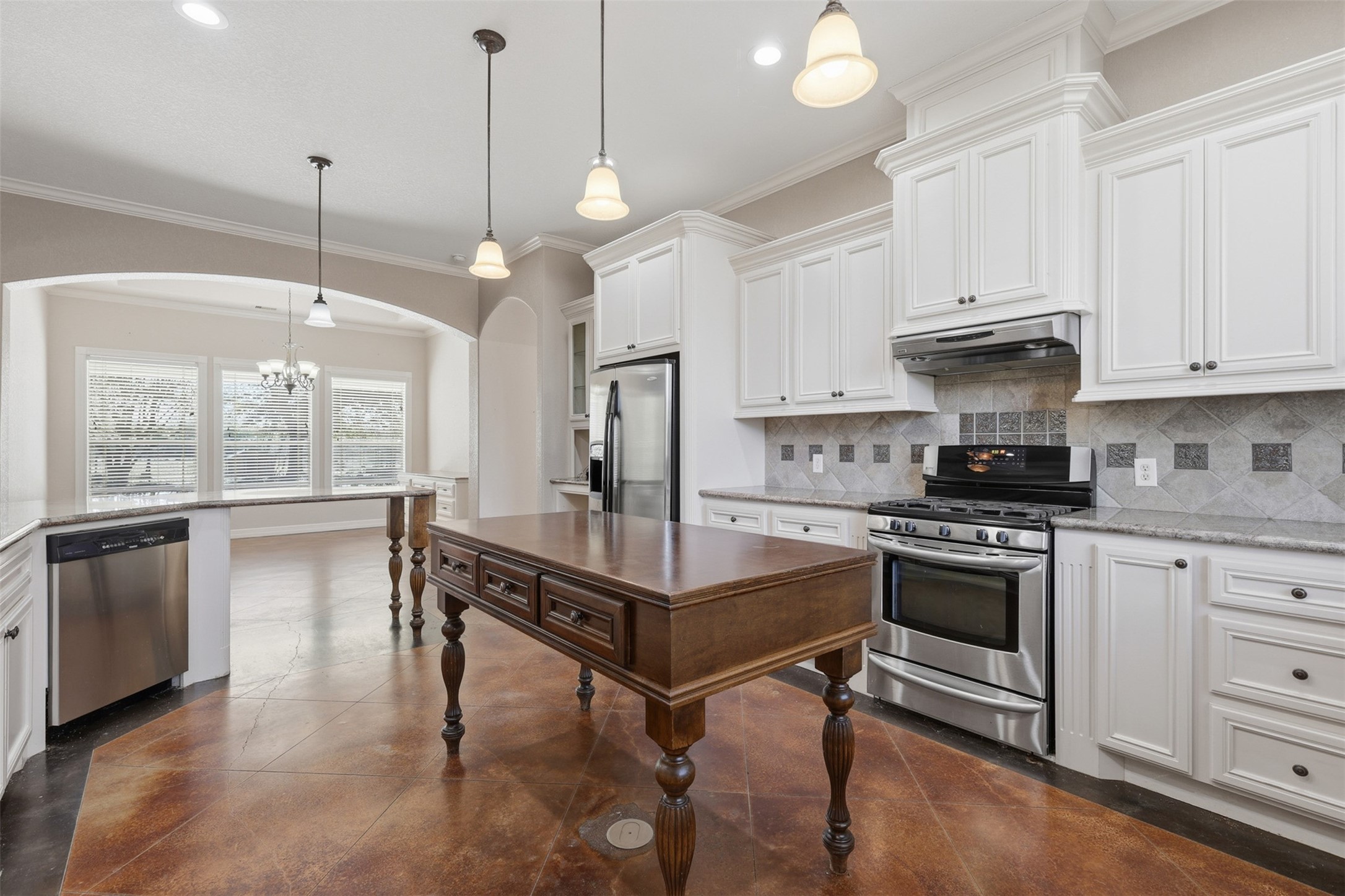 500 Burwell Road Highlands, TX 77562 - Photo 14 of 50 a kitchen with stainless steel appliances granite countertop a stove a sink and a refrigerator