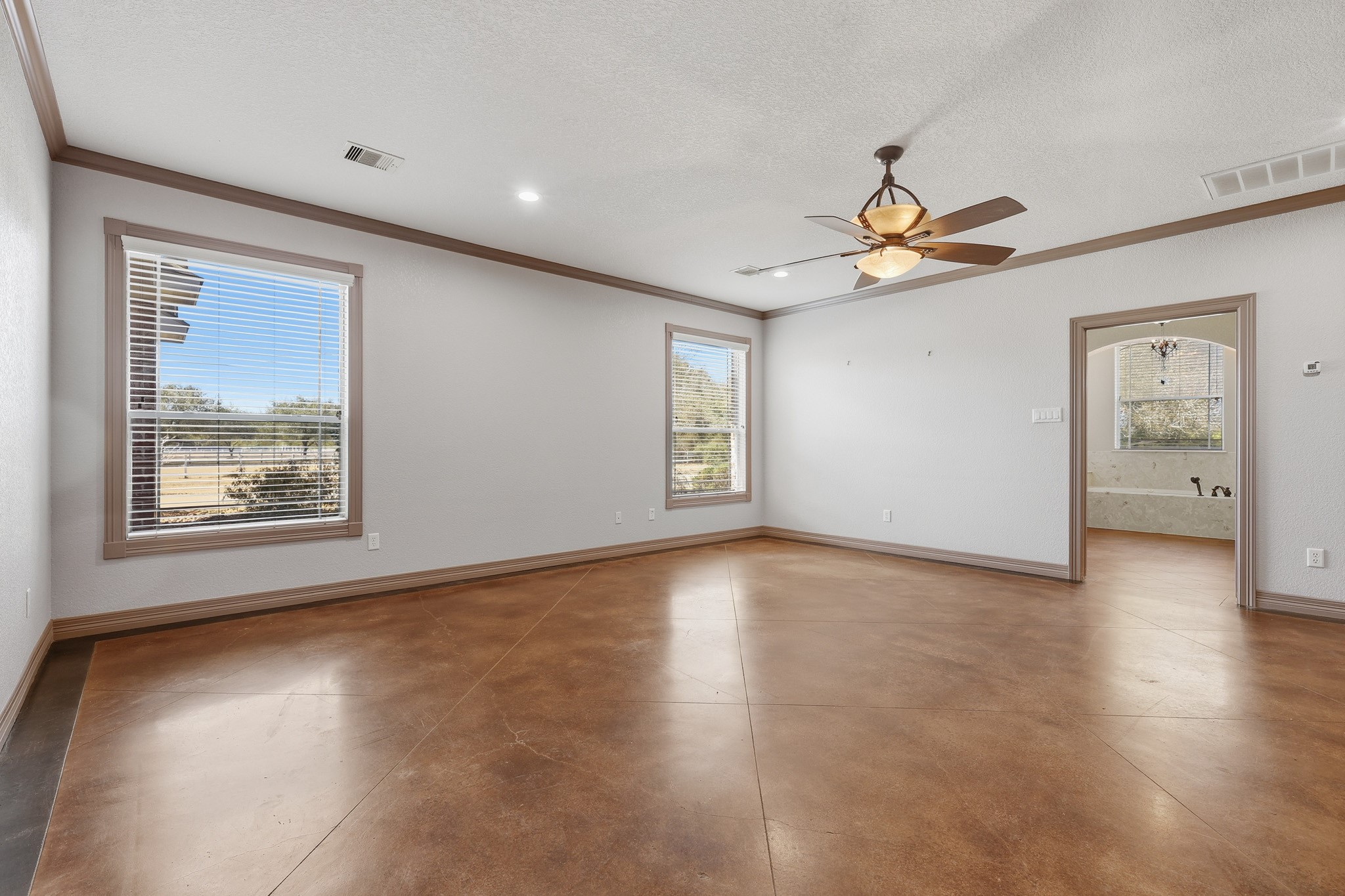 500 Burwell Road Highlands, TX 77562 - Photo 19 of 50 Primary bedroom is filled with natural light from multiple windows, creating a calm and relaxing retreat.