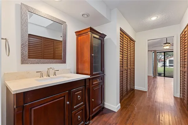 a bathroom with a sink a mirror and a shower