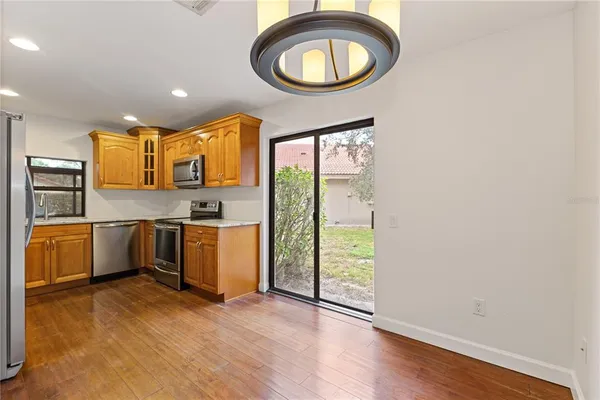 a kitchen with a sink cabinets stainless steel appliances and a window
