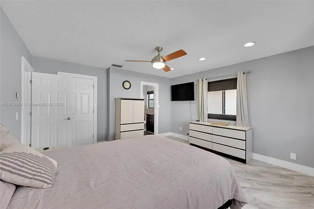 a bathroom with a granite countertop sink a toilet and a mirror