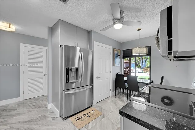 a kitchen with stainless steel appliances a stove a microwave a sink and cabinets