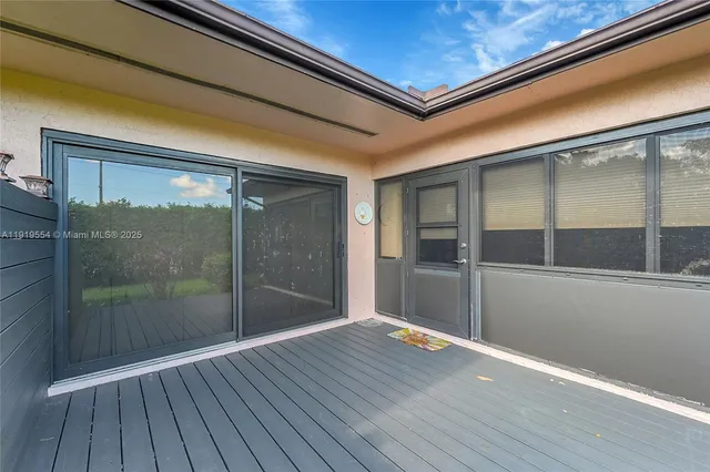 a front view of a house with a garden and plants
