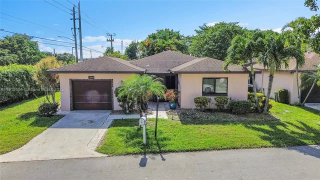 an aerial view of a house with a yard and garden