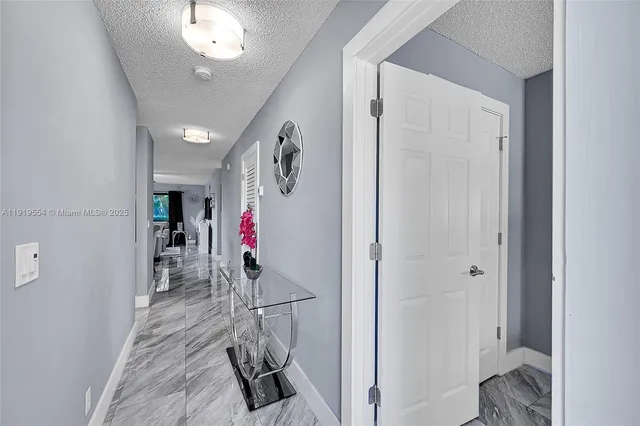 a bedroom with a large bed and a flat tv screen on dresser