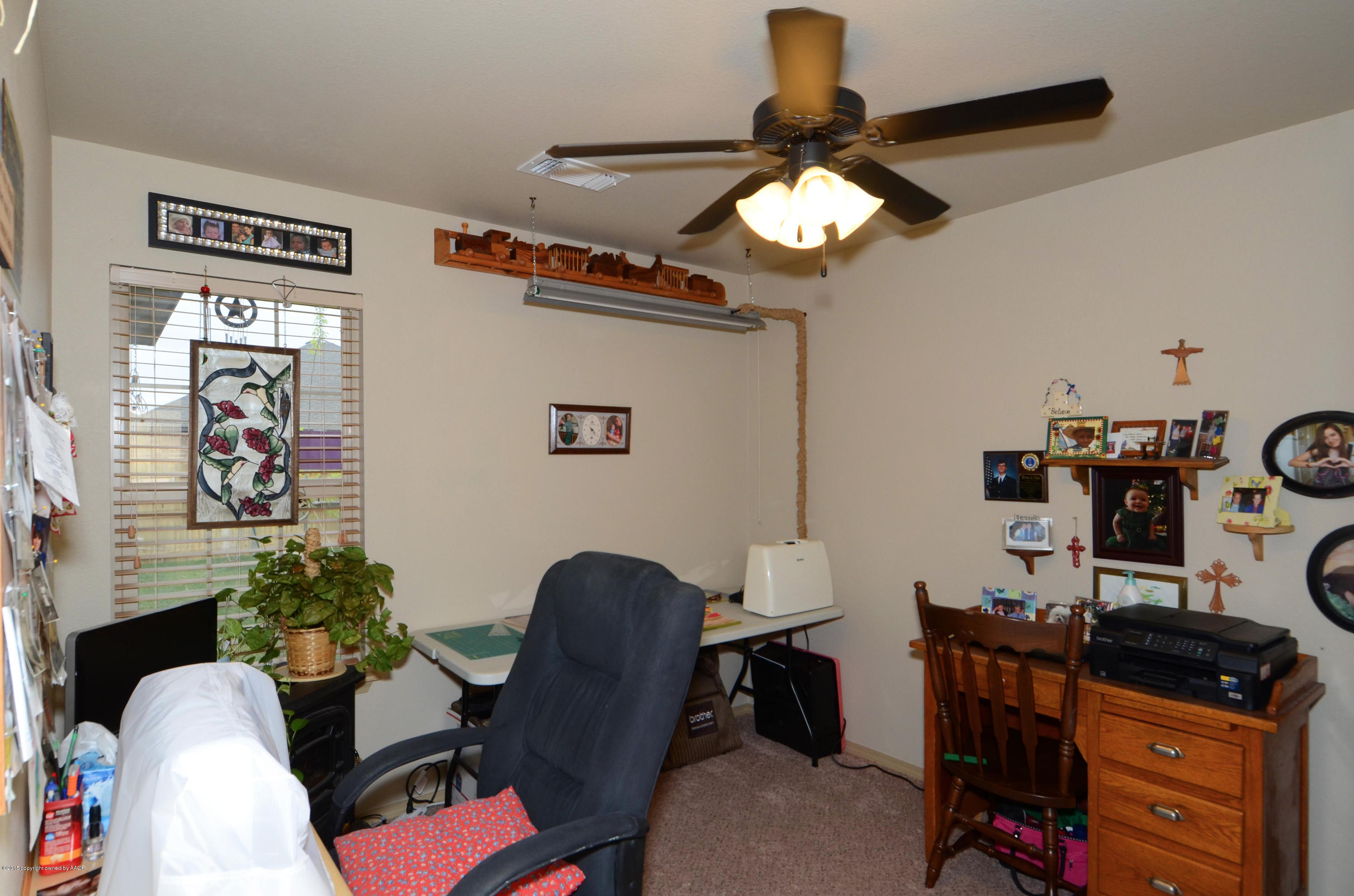 3705 Arden Road Amarillo, TX 79118 - Photo 14 of 20 a view of a workspace with furniture and a window