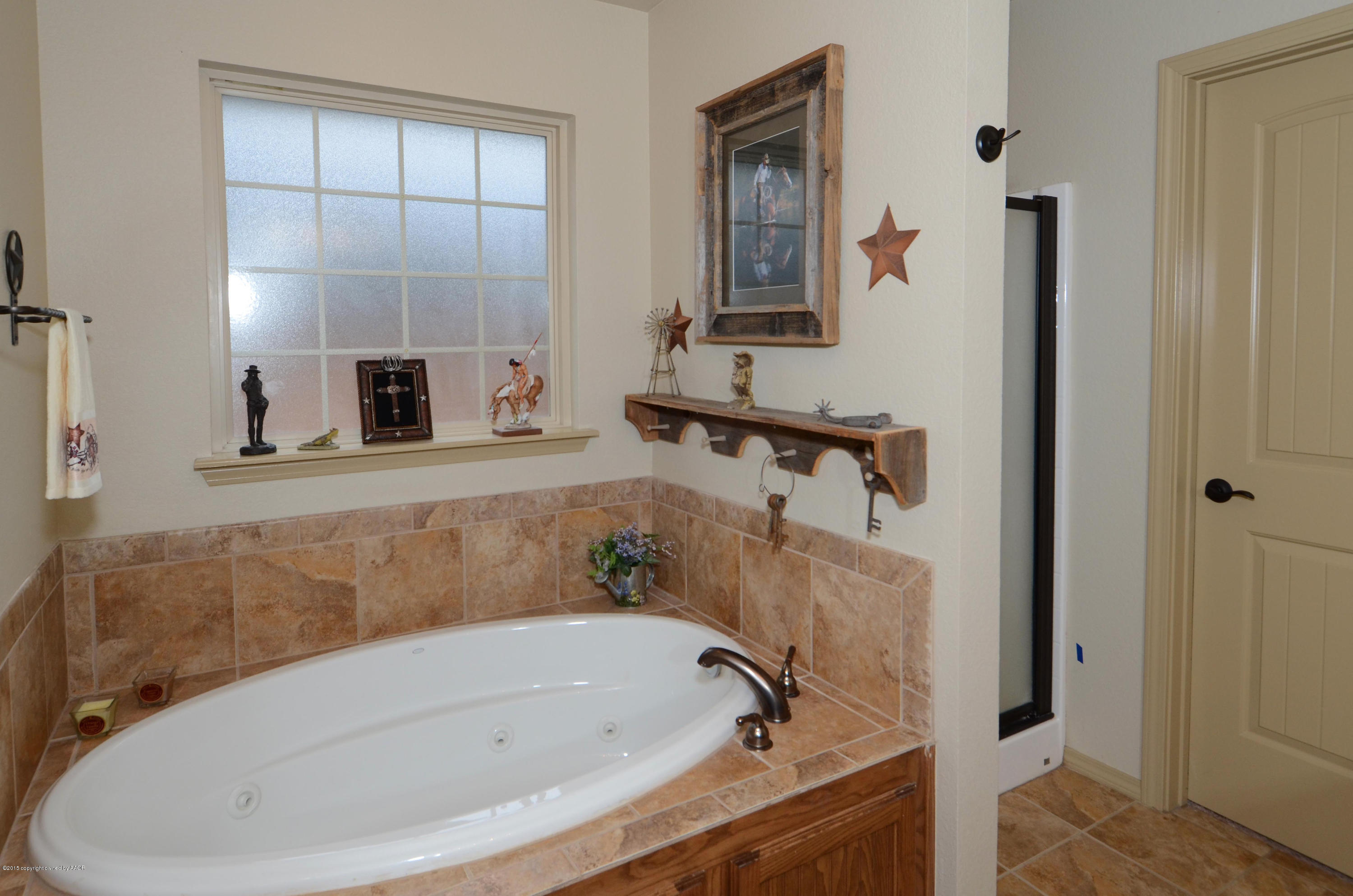 3705 Arden Road Amarillo, TX 79118 - Photo 17 of 20 a bathroom with a tub and shower