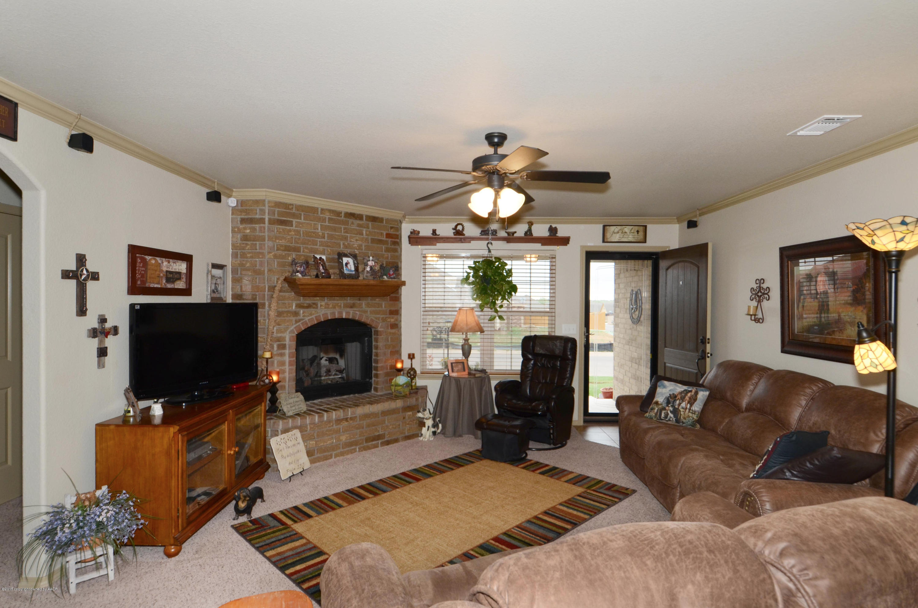 3705 Arden Road Amarillo, TX 79118 - Photo 2 of 20 a living room with furniture a fireplace and a flat screen tv