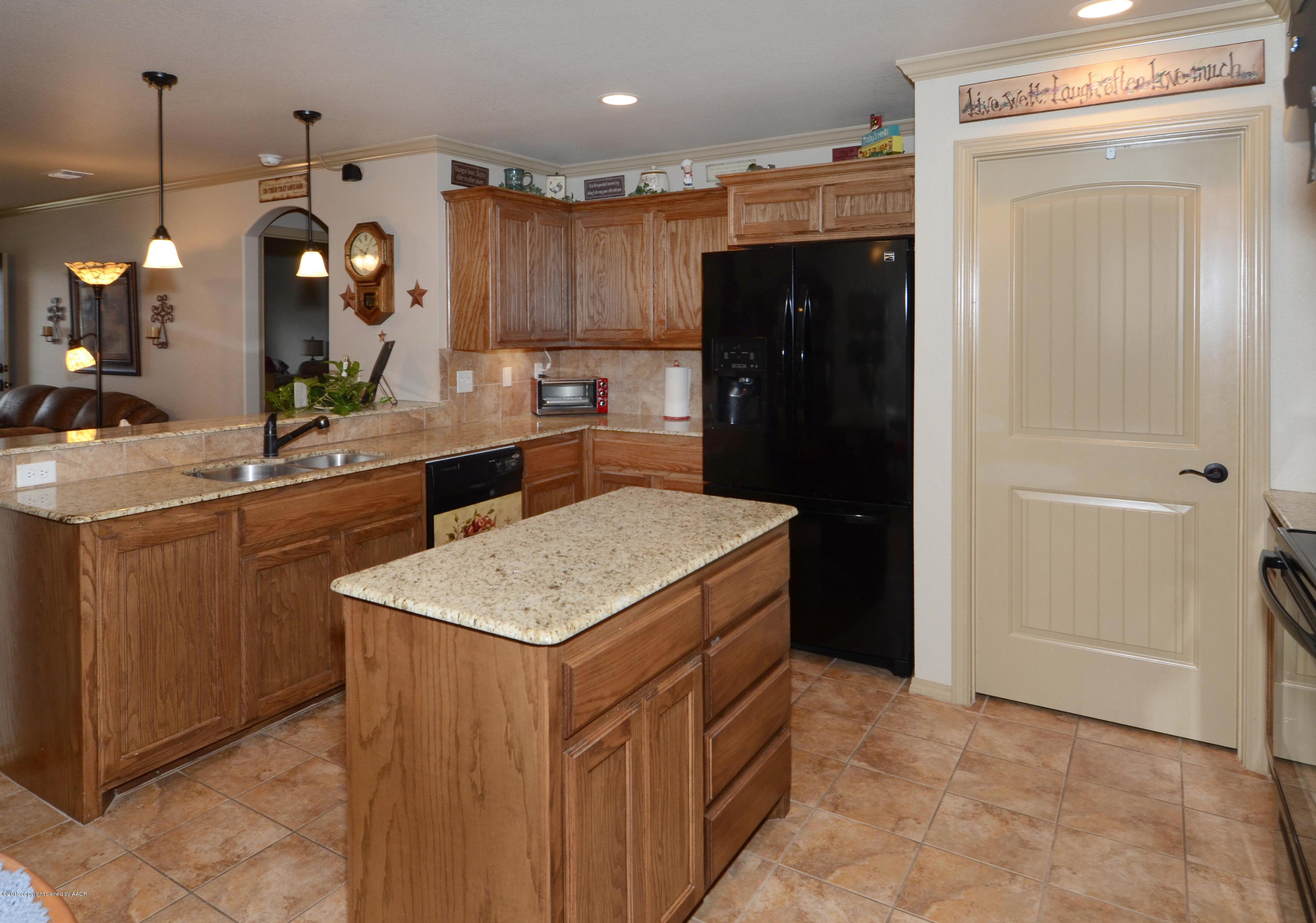 3705 Arden Road Amarillo, TX 79118 - Photo 5 of 20 a kitchen with a sink a counter space and stainless steel appliances