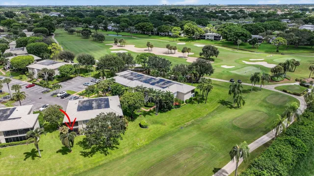 an aerial view of residential houses with outdoor space and trees