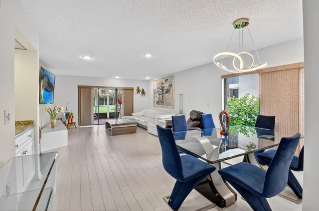 a living room with furniture large window and flat screen tv