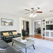 a living room with furniture and view of kitchen