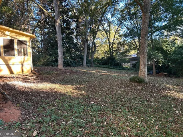 a view of a room with wooden floor and window