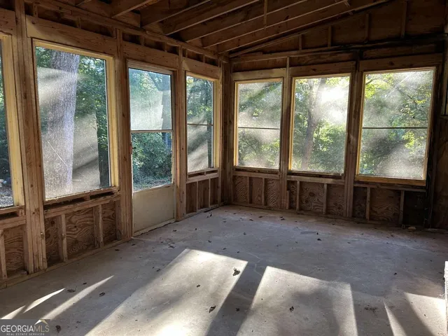 an empty room with a empty space and windows