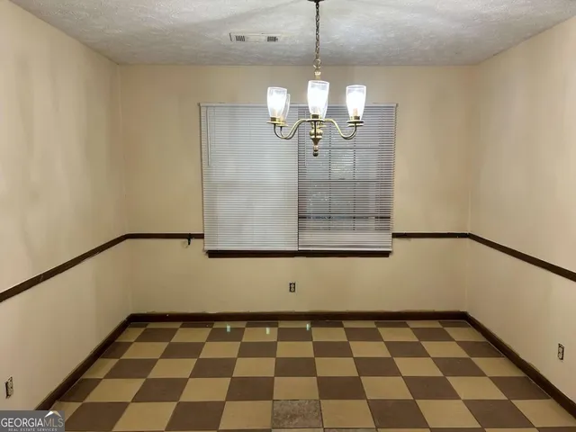 a view of a room with a black and white checkered floor