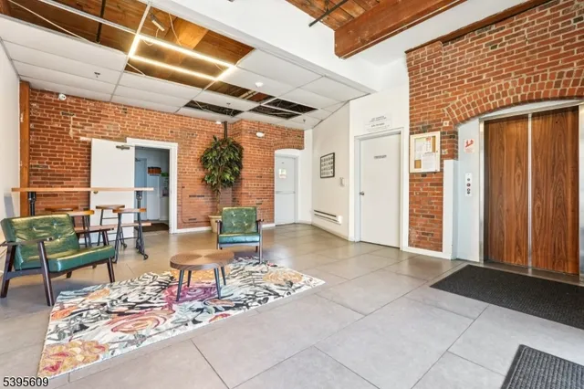a living room with furniture and a book shelf