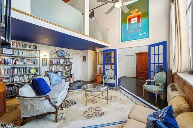 a living room with furniture and floor to ceiling windows
