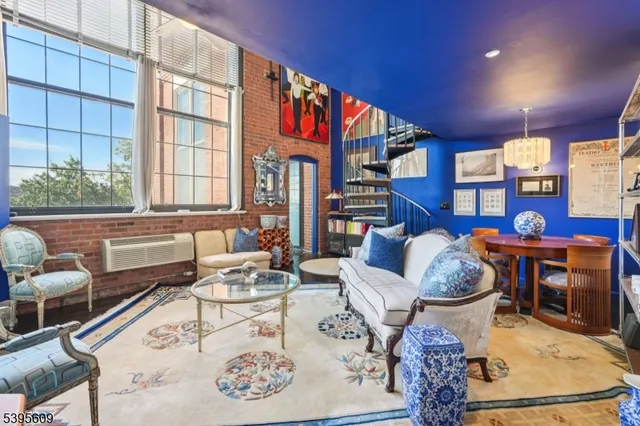 a living room with furniture and a book shelf