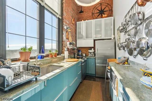 a kitchen with sink and view of living room