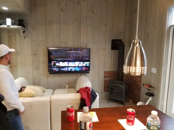 a living room with furniture a flat screen tv and a fireplace