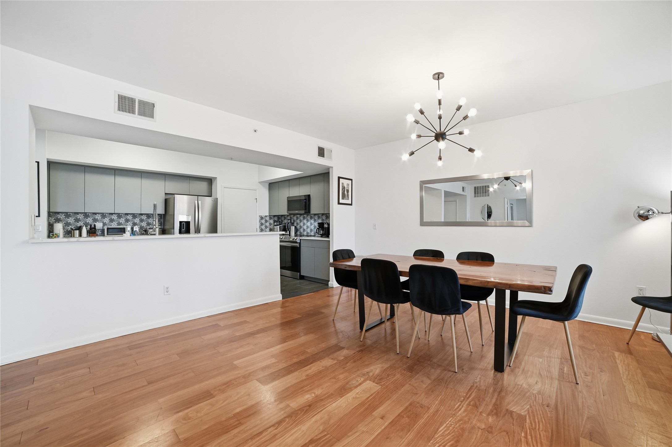 54 Rainey Street, Unit 1018 Austin, TX 78701 - Photo 12 of 32 a view of a dining room with furniture and wooden floor