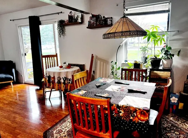 a outdoor dining space with furniture and wooden floor