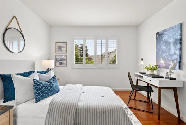a bedroom with a large bed and a window