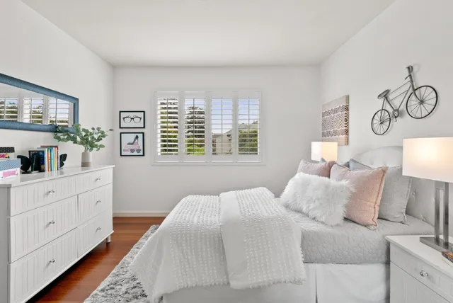 a bedroom with a large bed and a window