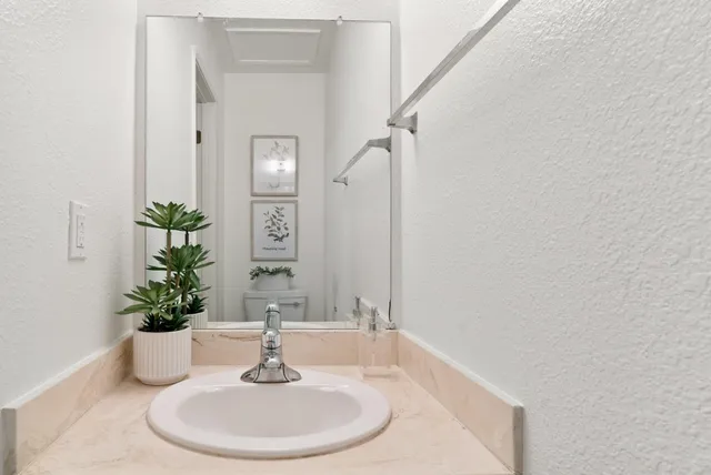 a bathroom with a sink and a mirror