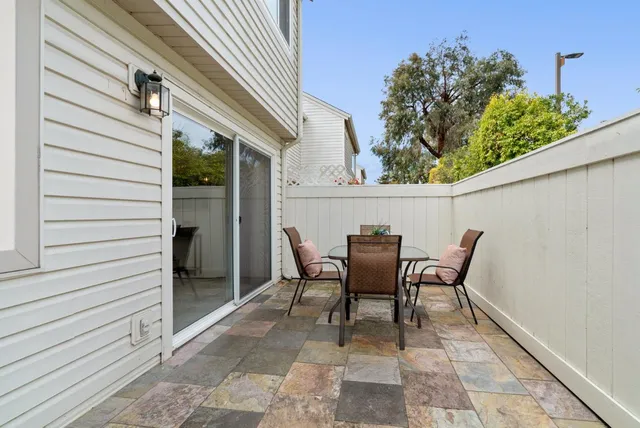 a view of a patio with table and chairs and potted plants