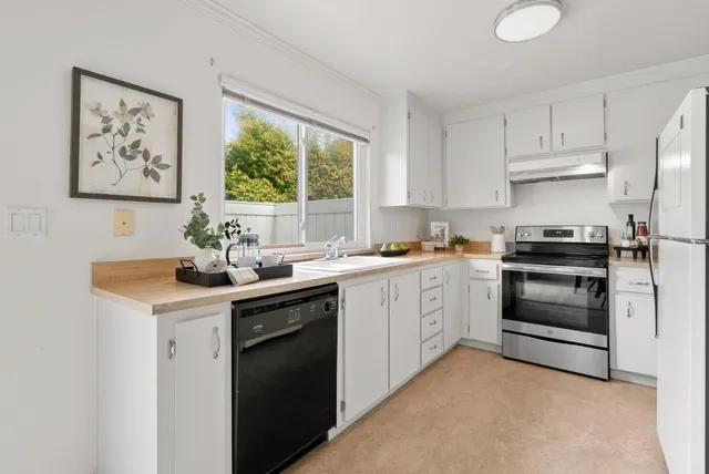 a kitchen with a sink stove and window