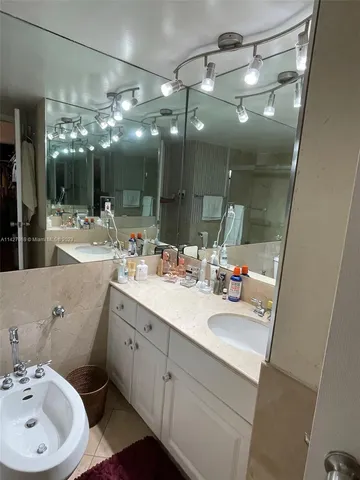 a bathroom with a sink double vanity and a mirror