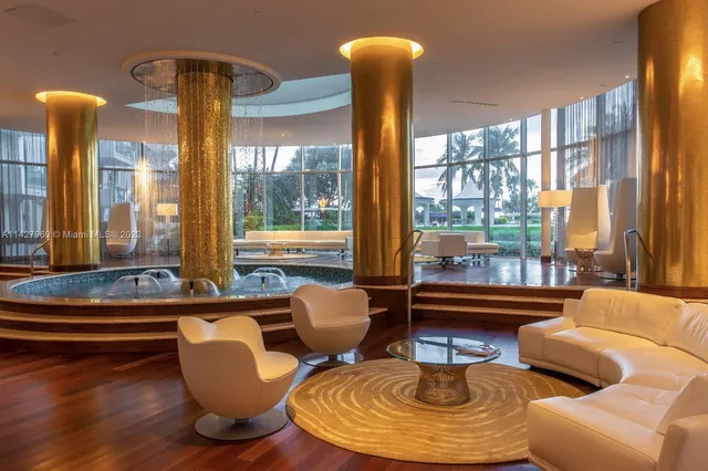 a dining room with furniture a chandelier and wooden floor