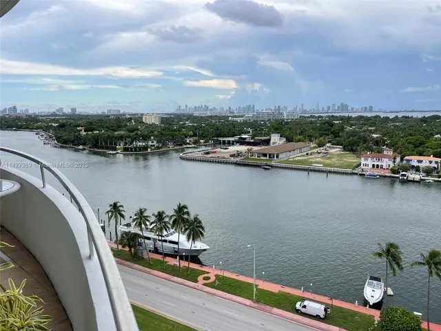 a view of a lake with a table and chairs