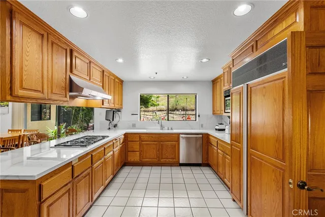 a kitchen with stainless steel appliances granite countertop wooden cabinets a sink and dishwasher