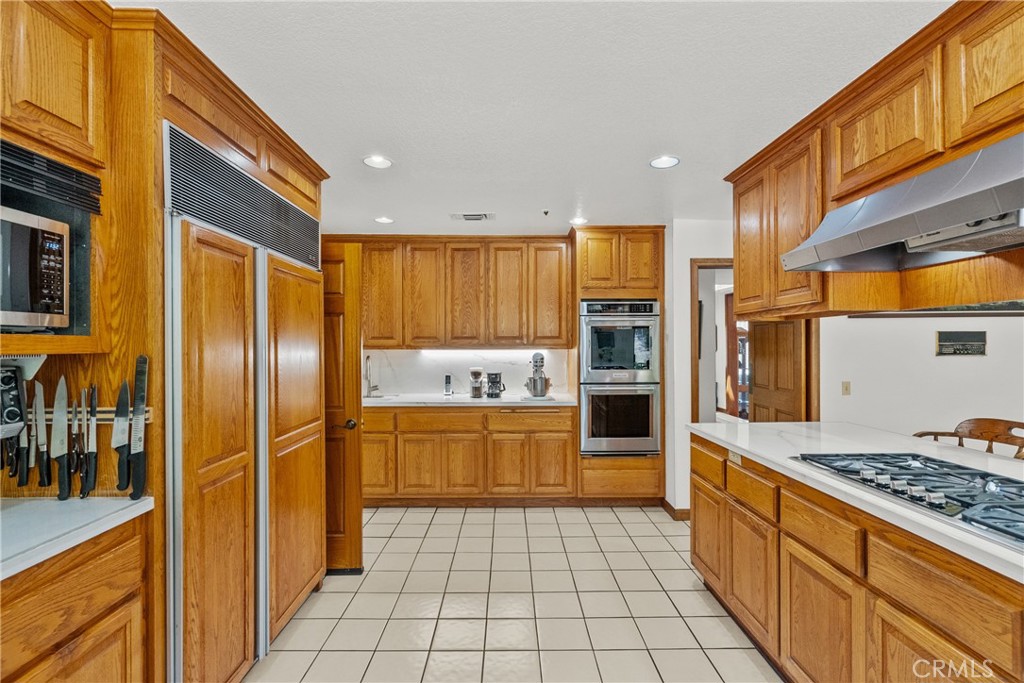 52 Hidden Valley Road Monrovia, CA 91016 - Photo 23 of 55 a kitchen with stainless steel appliances granite countertop a refrigerator and a stove top oven
