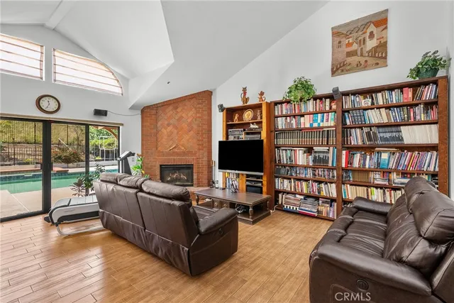 a living room with furniture ceiling fan and a wooden floor