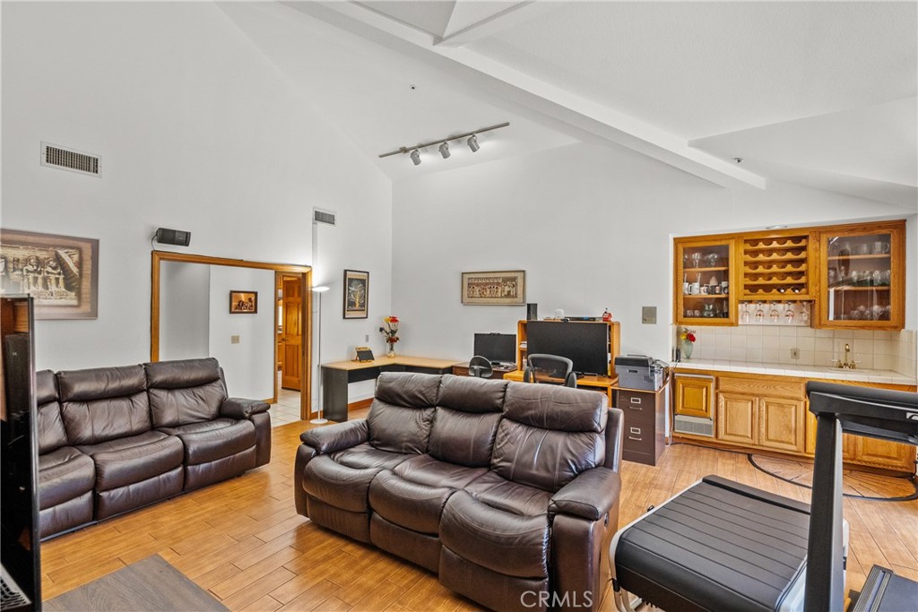 52 Hidden Valley Road Monrovia, CA 91016 - Photo 28 of 55 a living room with furniture ceiling fan and a wooden floor