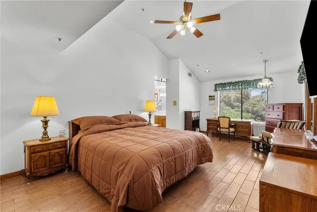 a dining room with furniture a chandelier and wooden floor