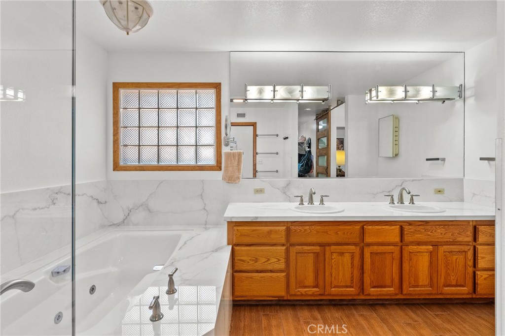 52 Hidden Valley Road Monrovia, CA 91016 - Photo 37 of 55 a bathroom with a double vanity sink a mirror and bathtub